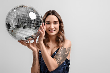 Naklejka premium Beautiful woman with disco ball on white background