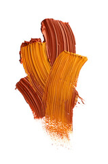 Brown and orange oil paint strokes on white background, top view