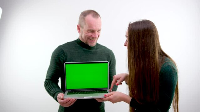 rear view of businessman looking at laptop with green screen in office. man showing laptop chroma key High quality photo