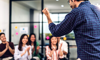 Businessman coach speaker presentation and discussing meeting strategy sharing idea.Creative team casual business people seminar and brainstorm in conference seminar at hall.presentation and teamwork