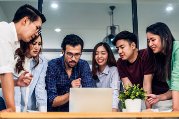 Group of creative asian business meeting and discussing strategy startup project analysis finance process.Success asian business people work plan and brainstorm marketing idea with laptop in office