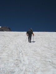 Fototapeta na wymiar One Person with Trekking Poles - Hiking Mount Rainier 