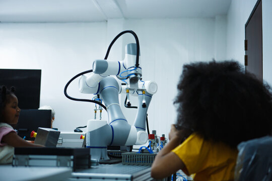 Kid-friendly Experiments to education learning technology science robotics mechanics classes intelligent smart, School children in the class, Robotic machine arm, Innovation technology and success