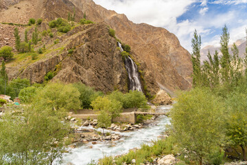 Mantoka Waterfall in Karakoram high mountain hills. Nature landscape background, Skardu-Gilgit, Pakistan. Travel on holiday vacation.