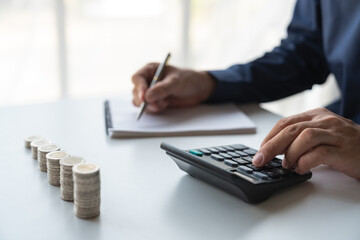 Business accounting for saving money Saving money of modern businessmen, retirees, teenagers Financial concepts on the table For calculations with a calculator to sort coins into a growing graph.