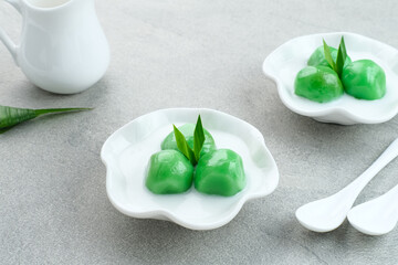 Kue Putri Mandi, Indonesian traditional dessert made from steamed glutinous rice filled with palm sugar paste and served with coconut milk. 
