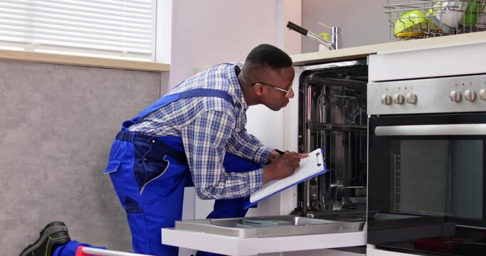 African American Repairman Fixing Dishwasher Appliance