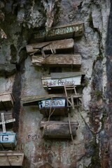 Close-up of the hanging coffins of Sagada on an imposing white rock face.