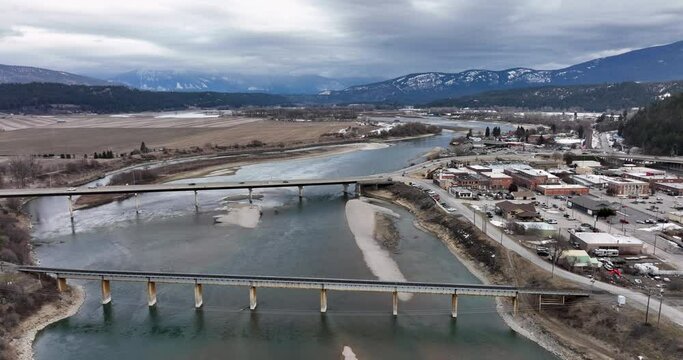Bonners Ferry Idaho Aerial Rising Shot Above Kootenay River Bends and Cityscape Winter Mountain Backdrop