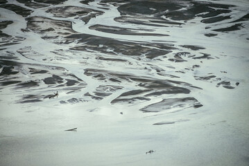 Atmospheric monochrome landscape with many channels near shallow lake. Minimal backdrop of gray...