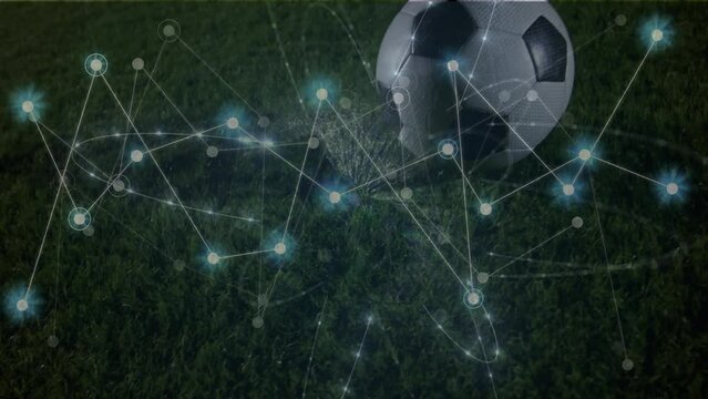 Animation of network of connections with icons over football player kicking ball on pitch