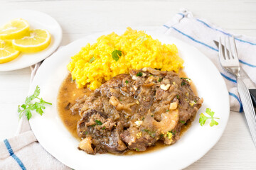 Authentic Ossobuco Milanese with saffron risotto, a one-dish course, a traditional Italian recipe. 