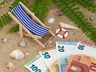 deck chair with euro banknotes in the sand with sea shells and tropical background, concept of...
