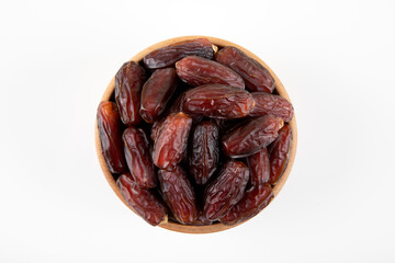 Date fruits in wooden bowl,on white background,top view