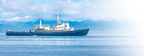 rescue ship in the Avacha Bay of the Pacific ocean in soft sunlight