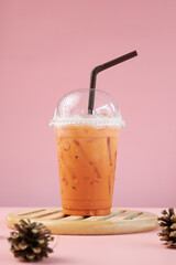 Thai style cold drink in plastic glass. Thai Iced Milk Tea in cup.