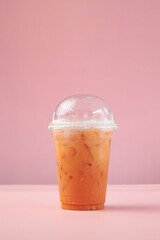 Thai style cold drink in plastic glass. Thai Iced Milk Tea in cup.