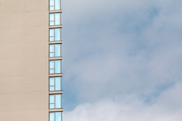 Part of the facade of a modern building with rectangular windows.
