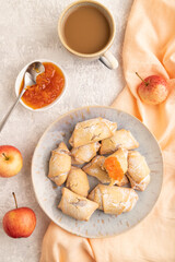 Homemade sweet cookie with apple jam and cup of coffee on gray concrete. top view.