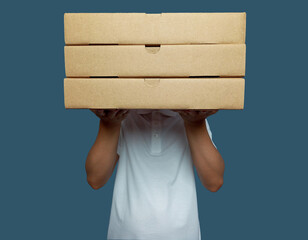 Man held up three brown cardboard boxes and covered his face