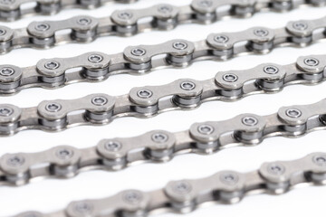 Closeup of New Clean Oiled Bicycle Chain Image Texture Isolated Over White Background With Focus in the Middle of Chain.