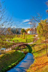 Fototapeta na wymiar Belarus Travel Places. Cityscape of Old city Grodno In Autumn Morning With Old Houses and River Embankment In background Against Sunny Sky