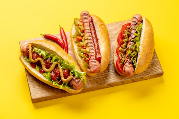 Various hot dog on wooden board