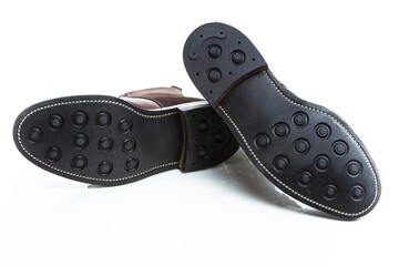 Footwear Ideas. Closeup of Soles of Premium Dark Brown Grain Brogue Derby Boots Made of Calf...