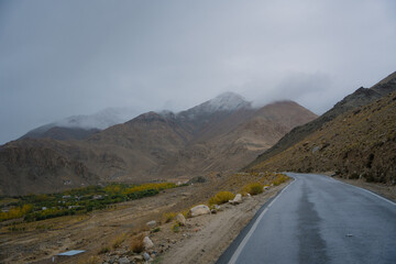 Beautiful view mountain and street view of Khardung La Pass- Leh road on the high mountain covered with snow. It is the highest pass in the world that motorbikes can run through at Ladakh, Leh, India