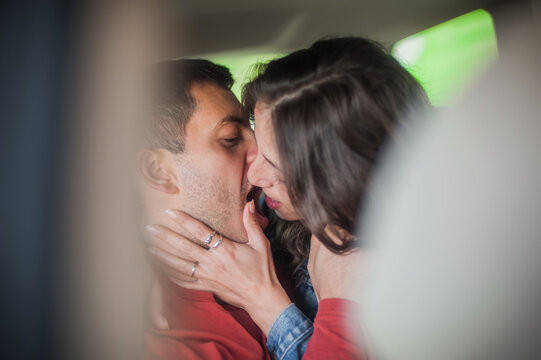 Passionate Scene Of Young Sexy Couple Kissing And Having Sex In The Backseat Of A Car. Close-up. Desire, Passion And Love Concept