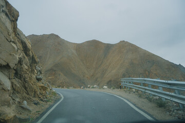 Beautiful view of Khardung La Pass- Leh road on the high mountain covered with snow. It is the highest pass in the world that motorbikes can run through at Ladakh, Leh, India