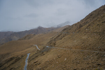 Beautiful view of Khardung La Pass- Leh road on the high mountain covered with snow. It is the highest pass in the world that motorbikes can run through at Ladakh, Leh, India