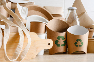 The concept of recycling and zero waste. Eco-friendly items made from biodegradable materials with a recycling sign.