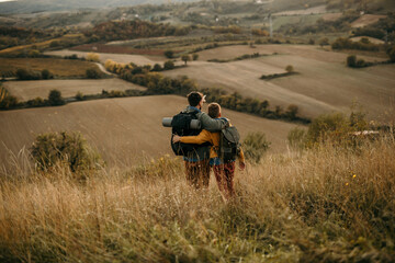Obraz premium Rear view shot of a father and son enjoying a day outdoors.