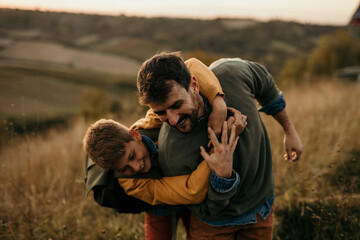 Naklejka na ściany i meble Shot of an active playful family of two, father and son, enjoying valley and mountain view in the national park. active family vacation concept
