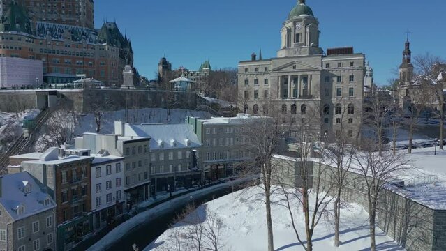 Quebec city in winter. Slow reveal of monument with clock. Drone Shot
