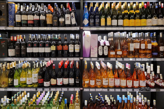 Penang, Malaysia - 15 Mar 2023: Wine bottles and liquor display on the shelves in store. Alcoholic drink produced by distillation of grains, fruits or sugar, that gone through alcoholic fermentation.