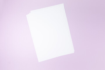 Obraz na płótnie Canvas empty white paper sheet on purple background. Mockup