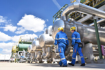 workers in an industrial plant for the production and processing of crude oil - 581351777