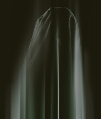 Somethings lurking in the shadows...A ghostly apparition of a woman isolated on a black background.