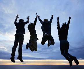 Celebrate life. Always. A group of young adults jumping in excitement against a twilight sky.