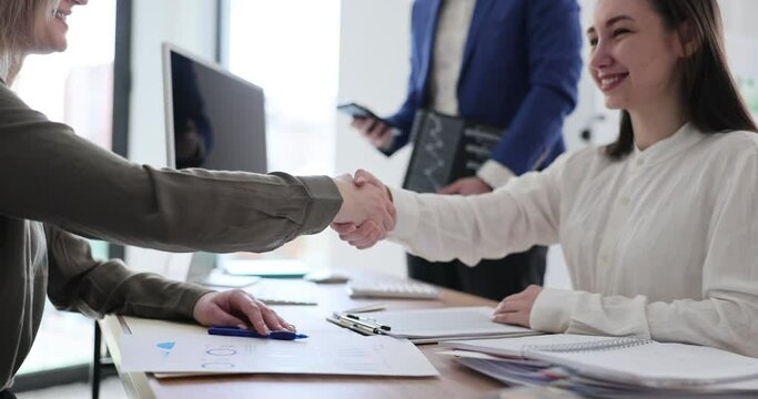 Business people in office and shake hands