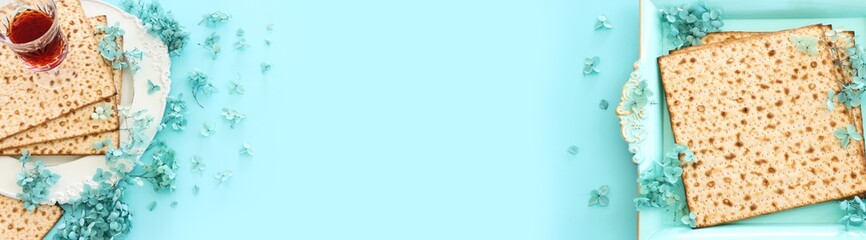 Pesah celebration concept (jewish Passover holiday) over pastel blue background