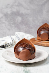 Chocolate cake. Bakery desserts. Delicious round portion cake with cream and dragee filling