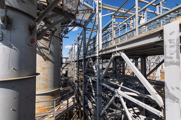 Fototapeta na wymiar View of the new technological overpass, metal structures and column block at the new refinery