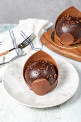 Chocolate cake. Bakery desserts. Delicious round portion cake with cream and dragee filling