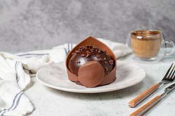 Chocolate portion cake. Bakery desserts. Delicious round portion cake with cream and dragee filling