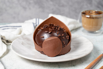 Chocolate cake. Bakery desserts. Delicious round portion cake with cream and dragee filling. Close up