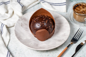 Chocolate cake. Bakery desserts. Delicious round portion cake with cream and dragee filling
