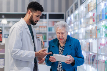 Young pharmacist helping senior woman to choos medication.